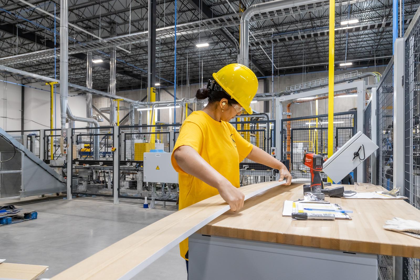 Woman holding a primed MDF baseboard