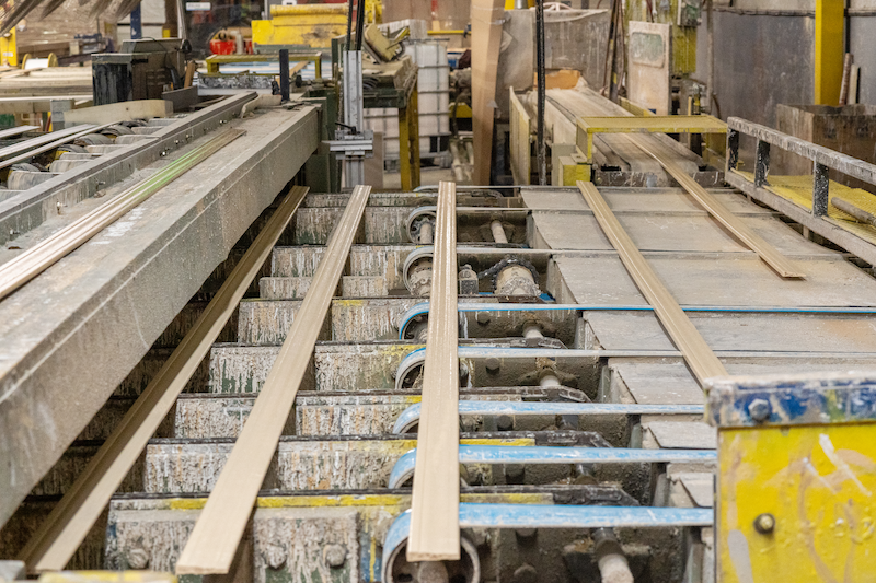 Pre-finished moulding conveyor belt loading raw trim