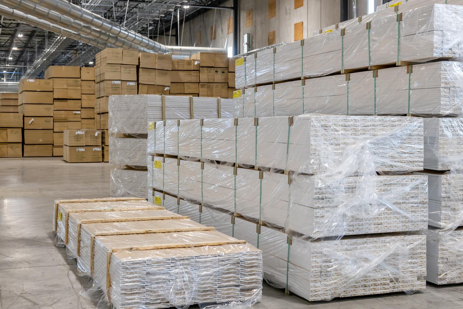 3 rows of stacked pallets of mdf pre-finished baseboard mouldings
