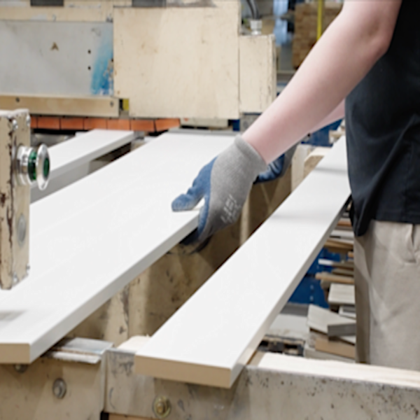 Employee moving moulding from the pre-finishing machine
