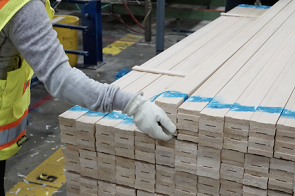 Solid Wood stacks and piled by a worker